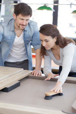 woman is brushing a snooker table