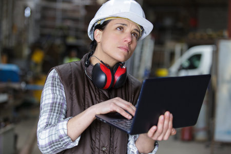female worker with laptop in a warehouse