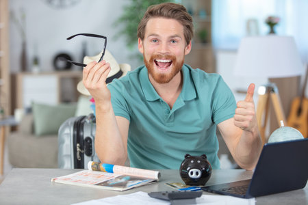 smiling young man freelancer using laptop at home