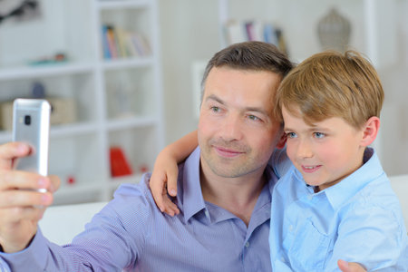 a father and son taking selfieの写真素材