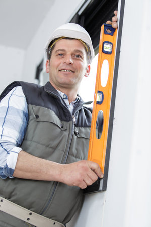 handsome builder with spirit level