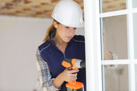 woman unscrews fastening screws handle window