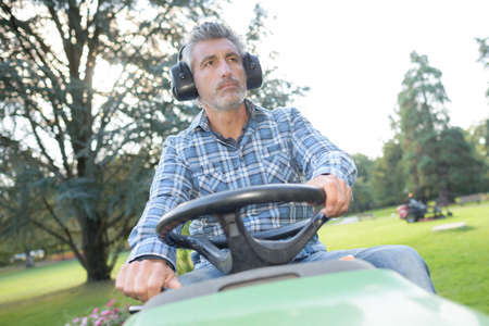 a man is mowing the parkの写真素材