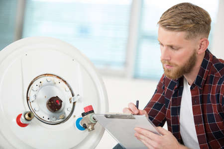 male worker checking a gas boilerの写真素材