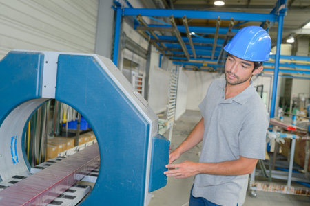 Factory worker controlling machine