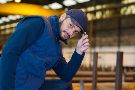 a factory worker tipping cap