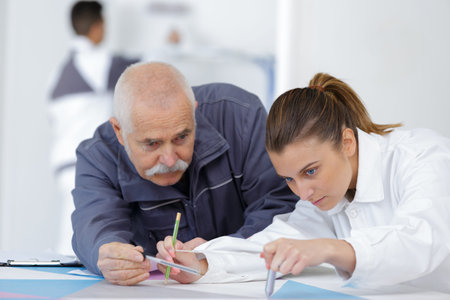 apprentice making design using a compass
