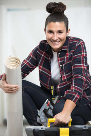 young woman renovating the floorの写真素材