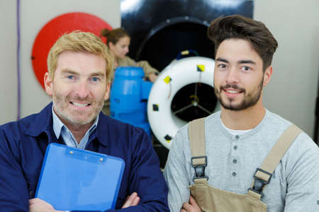 workers after fixing the engine of an airplaneの写真素材