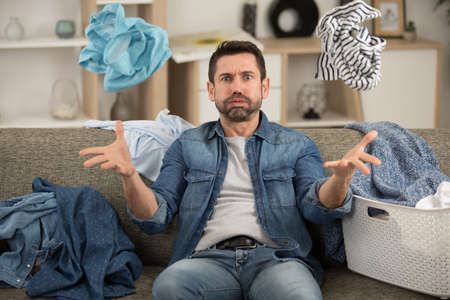 man helpless with dirty clothing after separating from wifeの写真素材