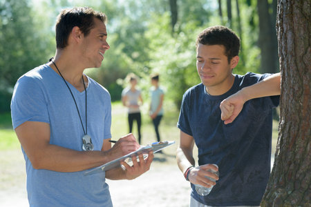 trainer talking to male sportsman after training