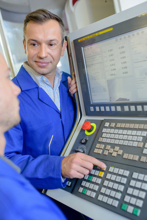 two workers during machinery operation