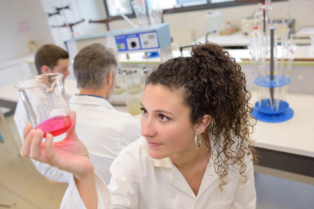 female laboratory assistant with chemical experiment
