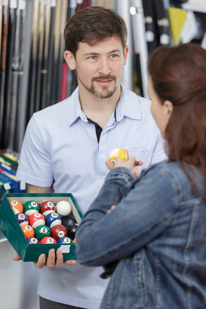 worker and customer in snooker store
