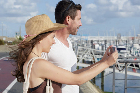 beautiful tourist couple taking a picture in the port
