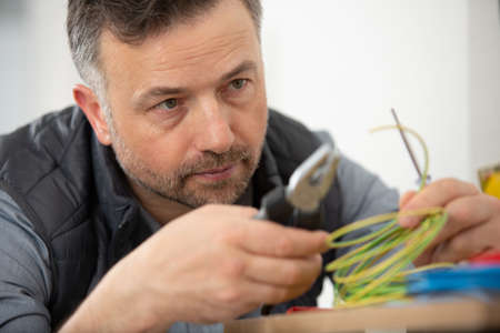 close view of male electrician using wire cuttersの写真素材