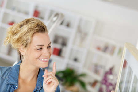 happy woman on a stepladderの写真素材