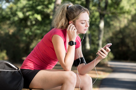 happy summer running woman runner listening to music on phone