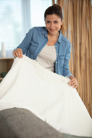 woman getting ready for a relaxing day on the sofaの写真素材