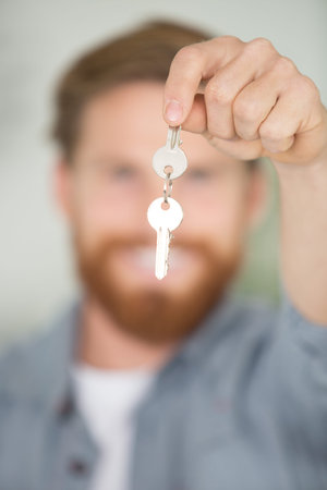 a man is holding a key