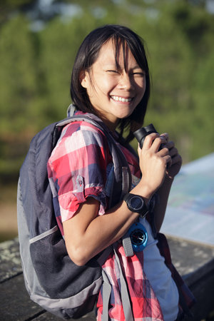 smiling young woman using binoculars