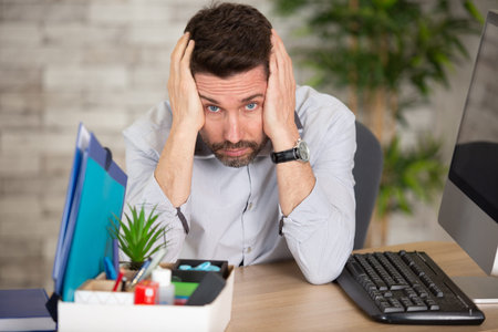 frustrated businessman sitting at office desk