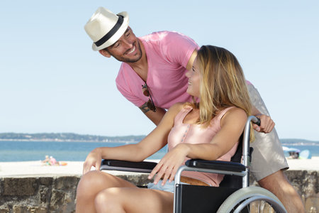 boyfriend and woman in wheelchairの写真素材