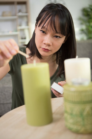 woman is lighting a candleの写真素材