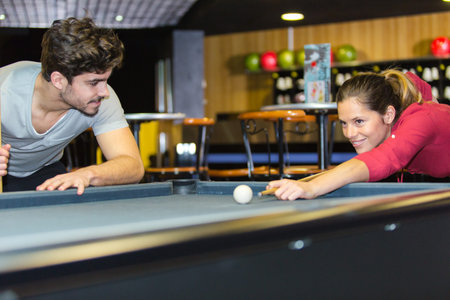 couple playing billiards and bonding