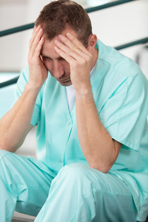 male nurse stressed in hospitalの写真素材