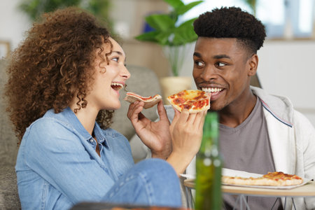 young couple sharing a pizzaの写真素材