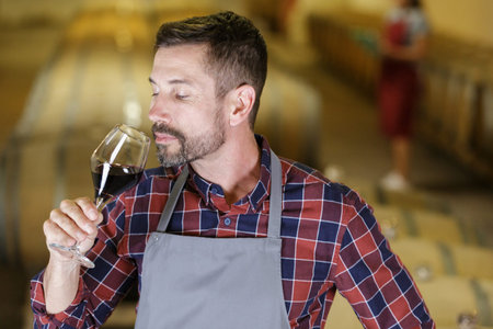 sommelier in cellar smelling wine