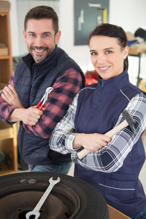 two mechanics smiling at the cameraの写真素材