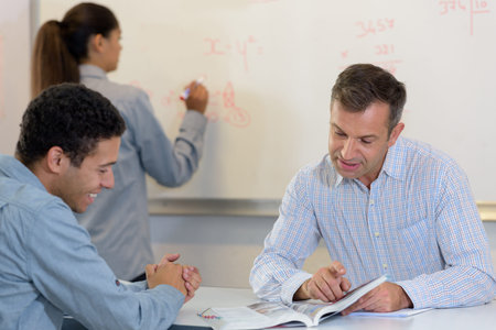 chemist student writing equations on a white board
