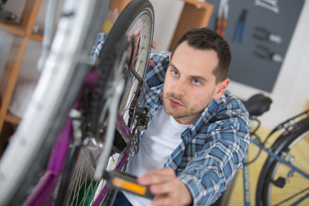 man checks bikeの写真素材