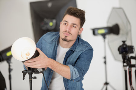 closeup view of professional photographer using a camera in studioの写真素材