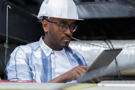 an engineer is checking a tabletの写真素材