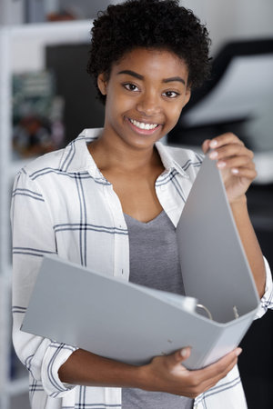 young female student holding an open folder
