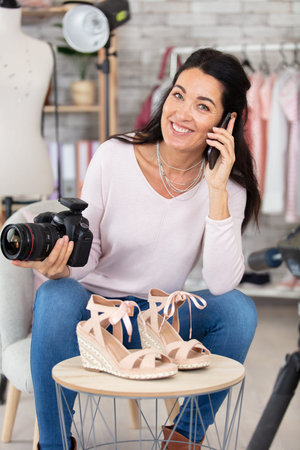 female photographer preparing shoe shootingの写真素材