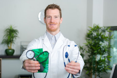 doctor holding devices for taking blood pressureの写真素材