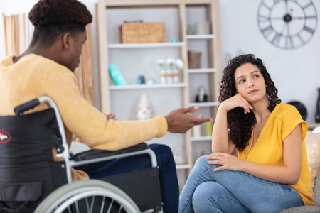 man in wheelchair quarrels with his girlfriendの写真素材