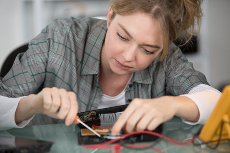 woman working with wires from the power supplyの写真素材