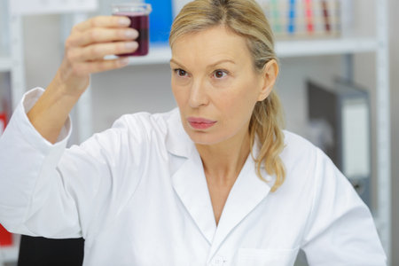 female doctor holding a testing urine sample