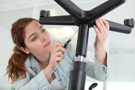 woman repairing a chair by handの写真素材