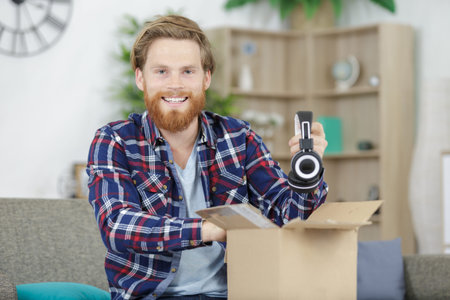 a man unboxing wireless headphones