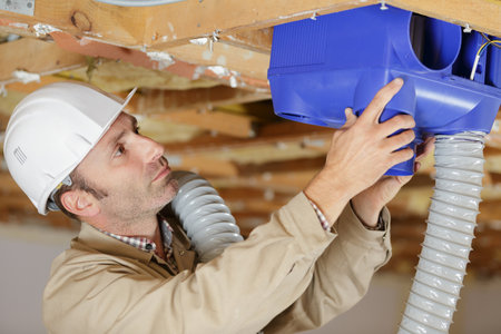 man installing an air conditioning unitの写真素材