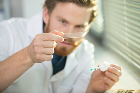 scientist holding laboratory test near the window