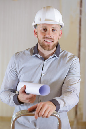 male architect on a ladder
