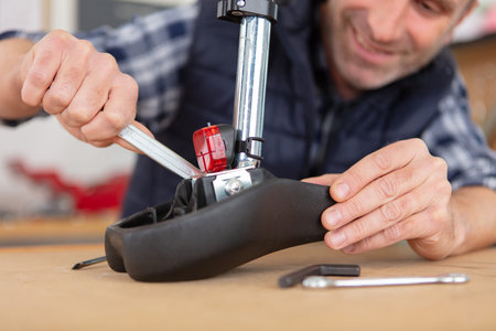young man repairing a bike with his toolsの写真素材