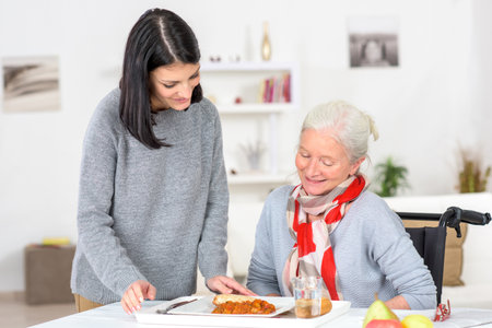 woman is serving the mealの写真素材